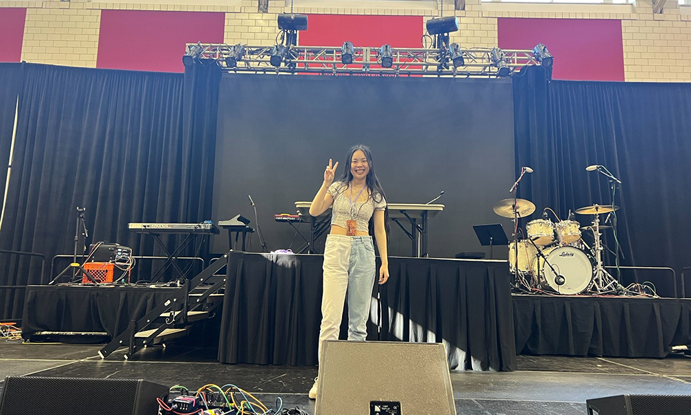 Claire Su stands on a stage set up for a concert