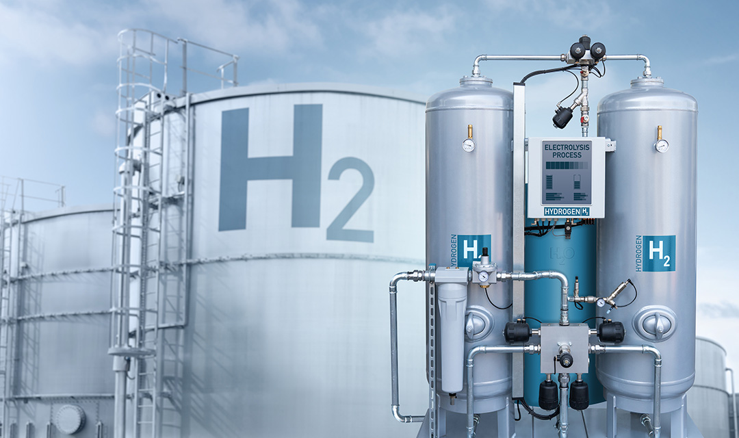 Two large tanks labeled Hydrogen next to a reactor for the production of hydrogen by electrolysis