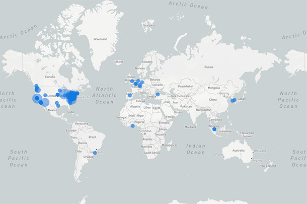 Locations on a world map are marked with blue circles of various sizes. The most and largest blue circles appear on the northeastern and western United States. There are also blue circles on Europe, South America, east and south Asia, and Africa.